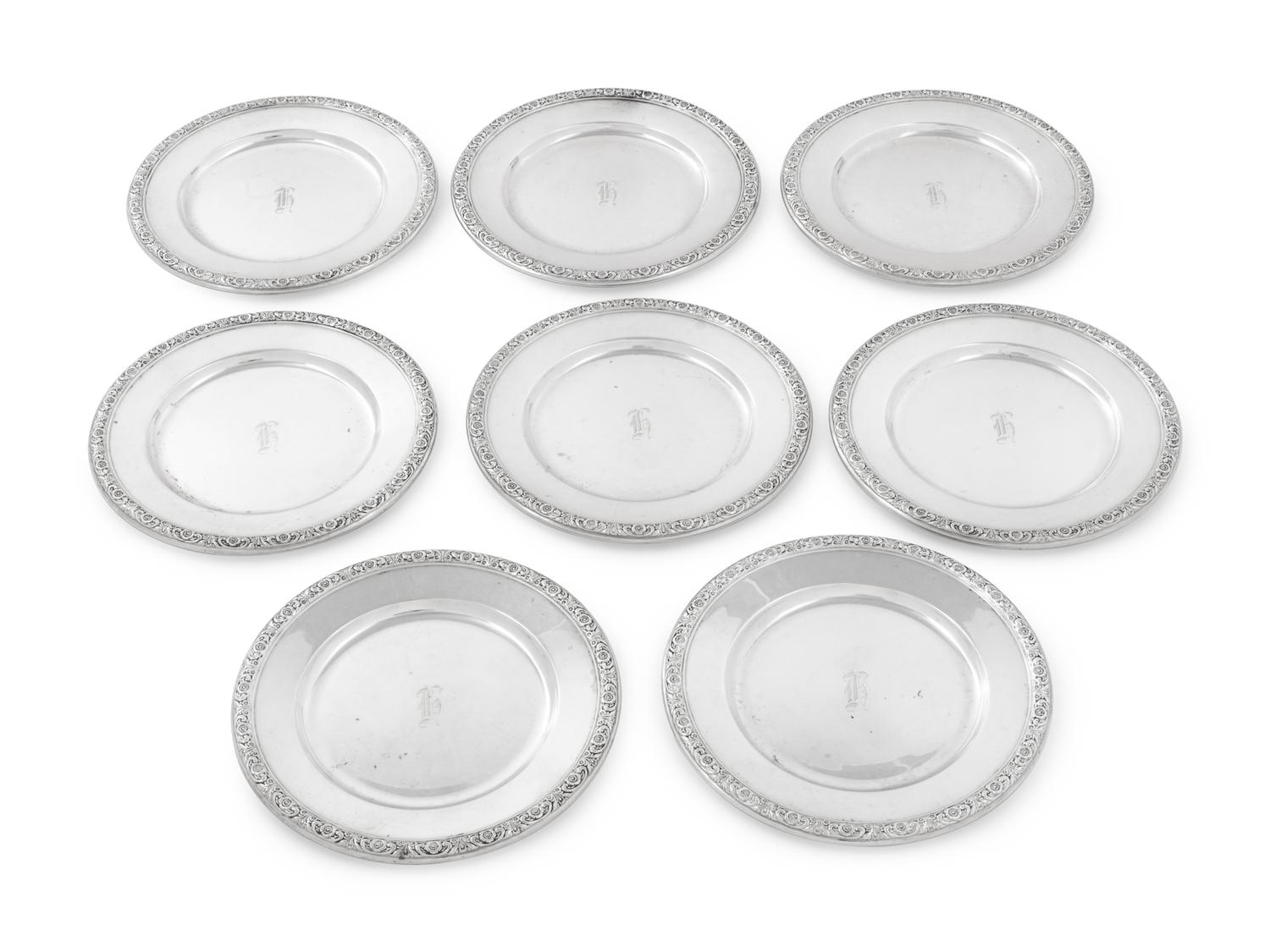 A Set of Eight International Sterling Bread Plates