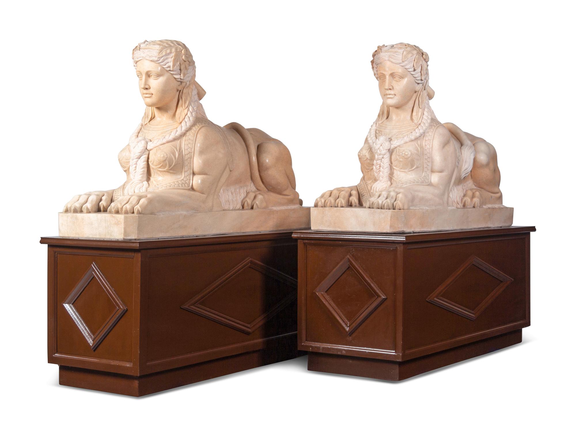 A Pair of Large Composite Marble Sphinxes