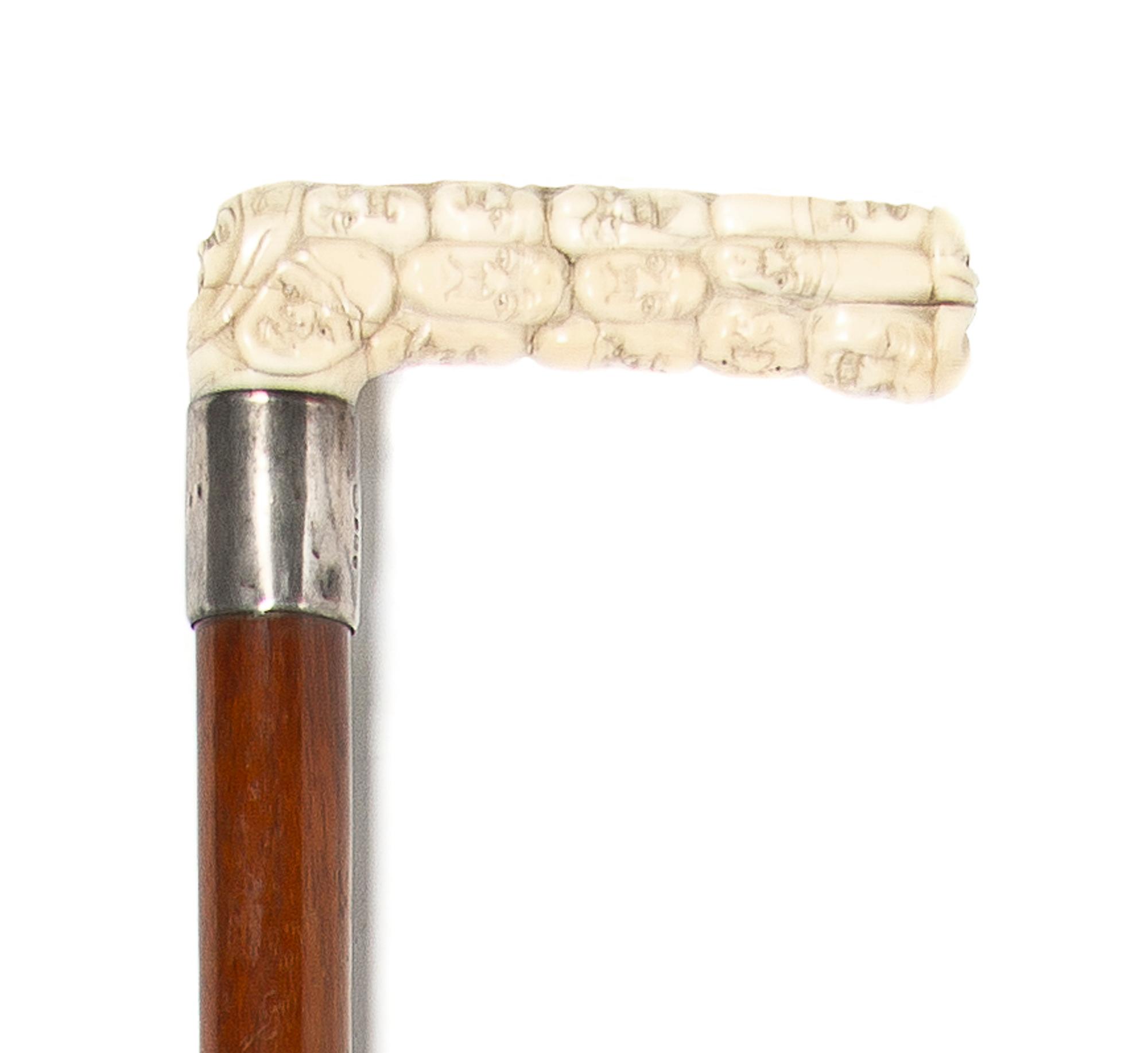 A Japanese Carved Ivory Cane Handle, Height overall 32 1/2 x width of handle 4 inches.