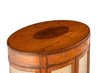 A George III Satinwood and Mahogany Oval Cabinet