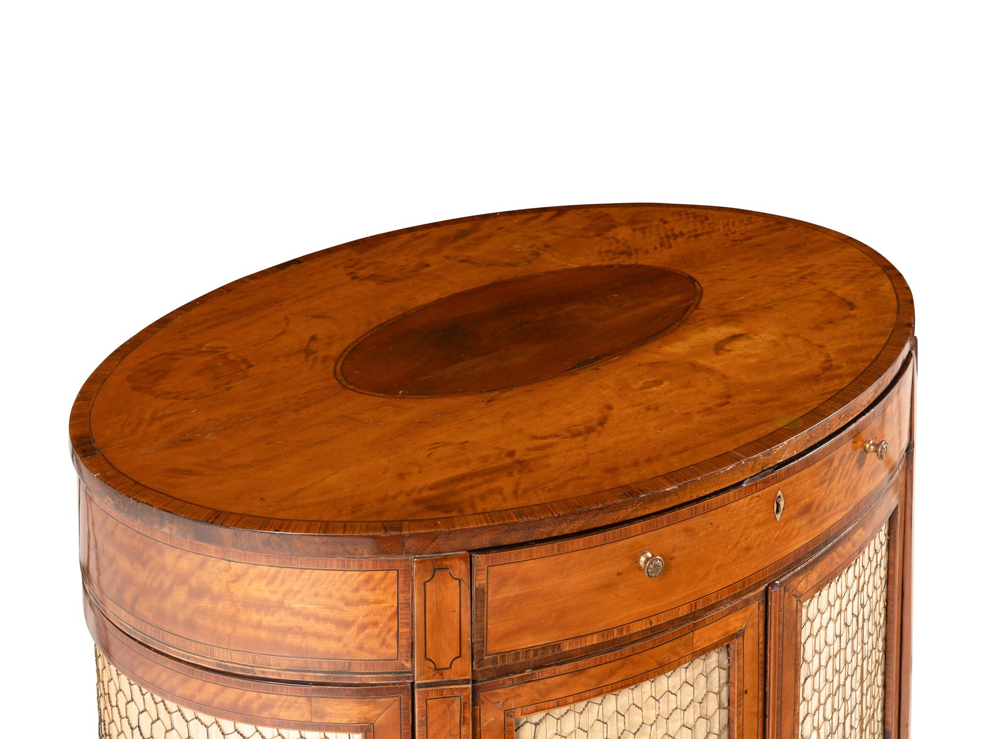 A George III Satinwood and Mahogany Oval Cabinet