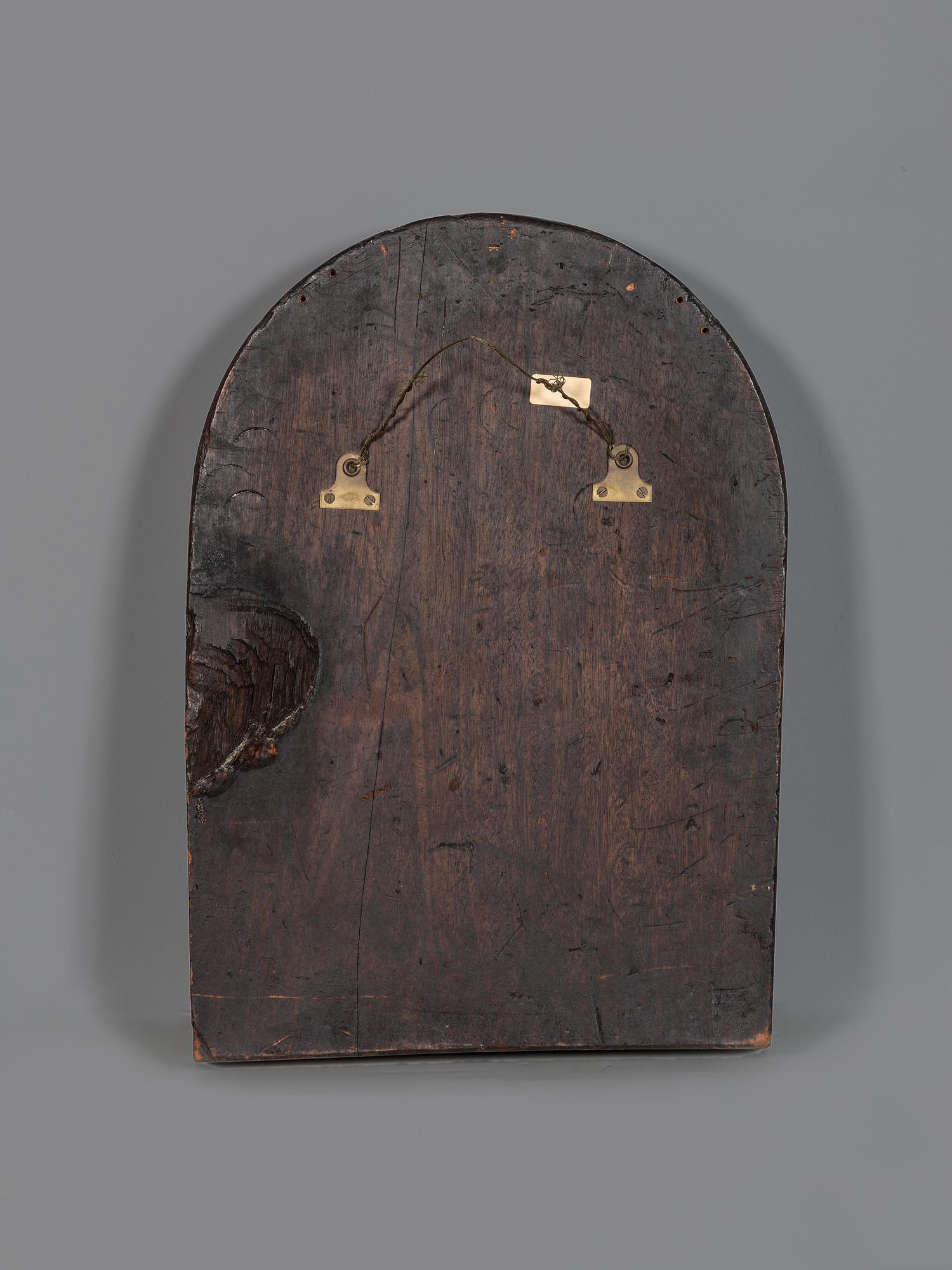 A Carved Walnut Ship Board Panel of a Sailor