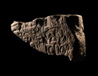 An Egyptian Limestone Relief Fragment Depicting an Attendant Wearing a Head-Cone