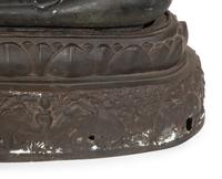 A Cambodian Bronze Figure of Seated Deity on Conforming Base
