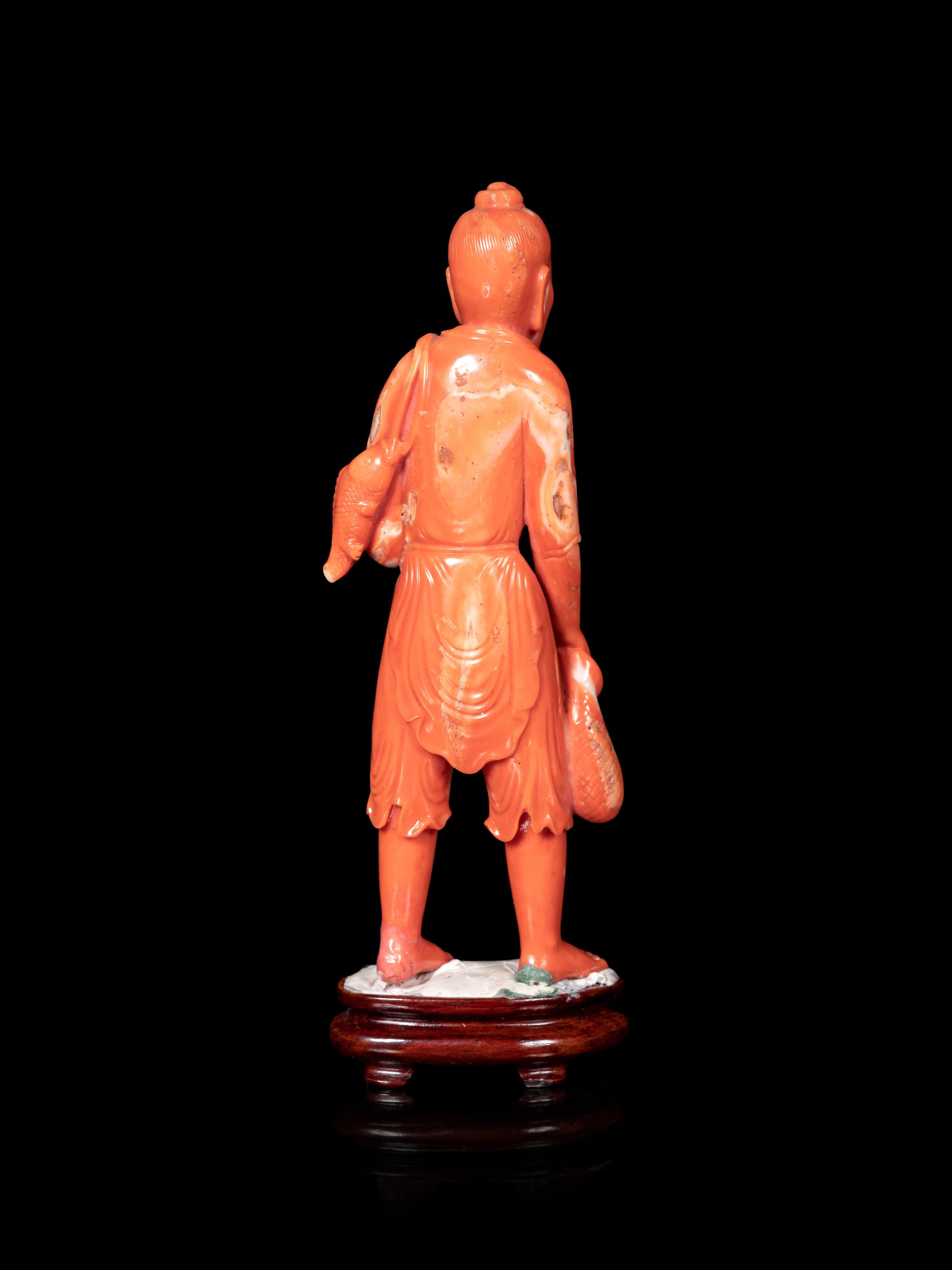A Chinese Red Coral Figure of a Fisherman
