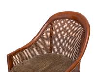 A Pair of Regency Style Walnut and Cane Barrel Chairs