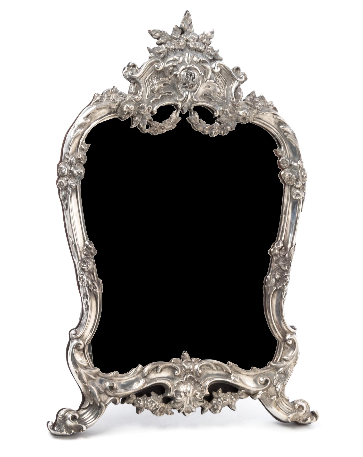 A Russian Silver Table Mirror, Mark of Faberge, St. Petersburg, 20th century, having a floral crest above an applied double-headed eagl