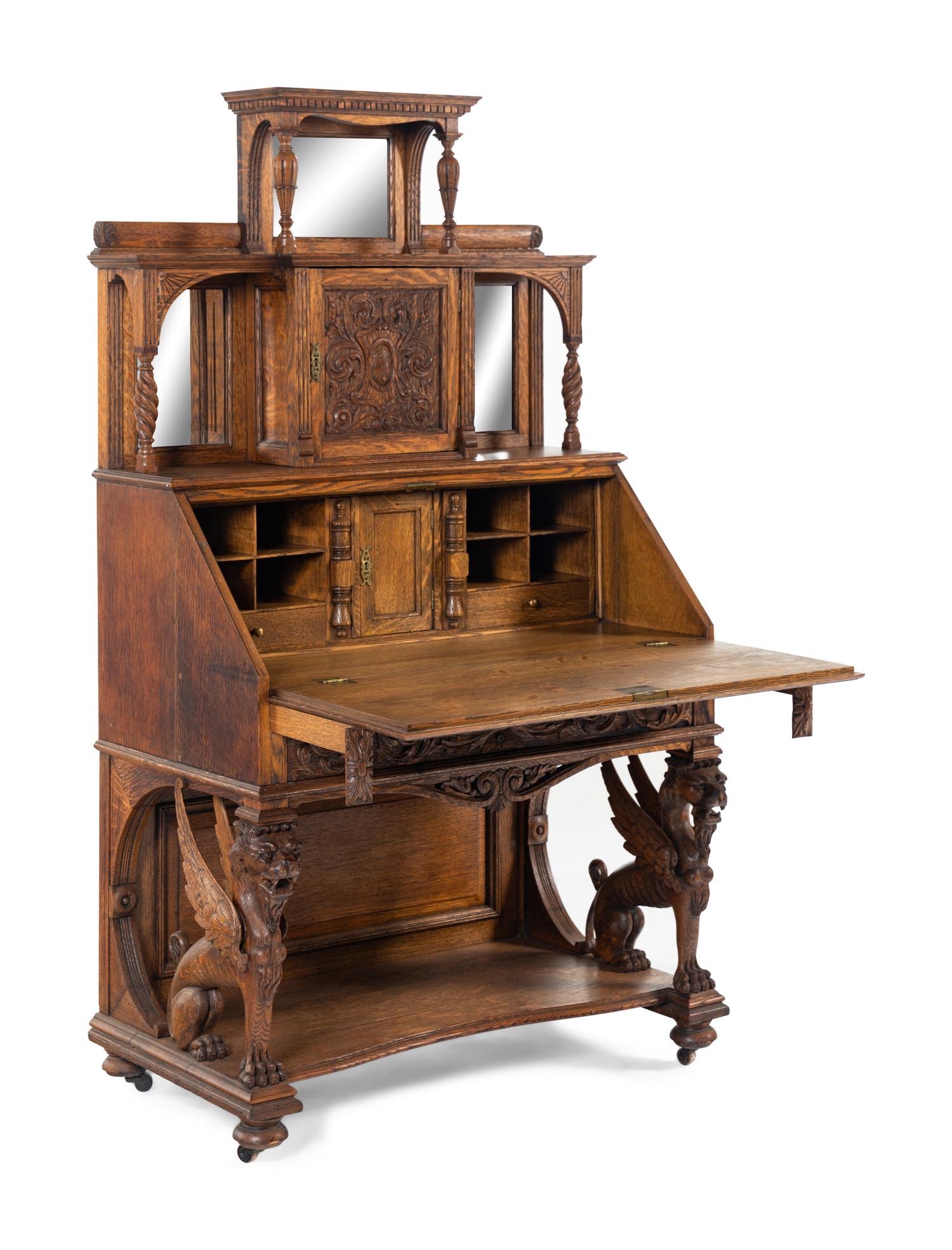 A Renaissance Revival Carved Oak Slant-Front Bureau