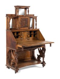A Renaissance Revival Carved Oak Slant-Front Bureau