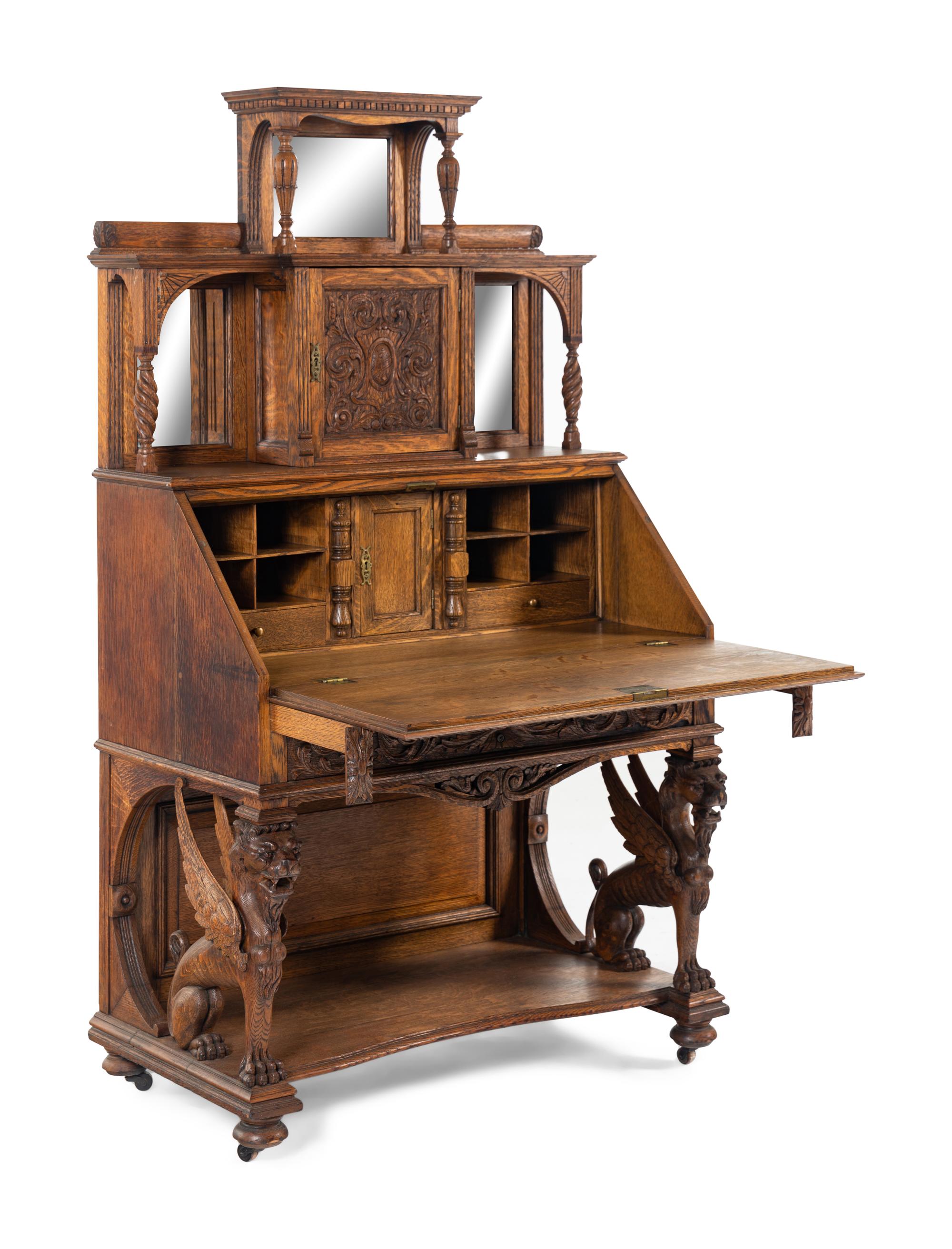 A Renaissance Revival Carved Oak Slant-Front Bureau