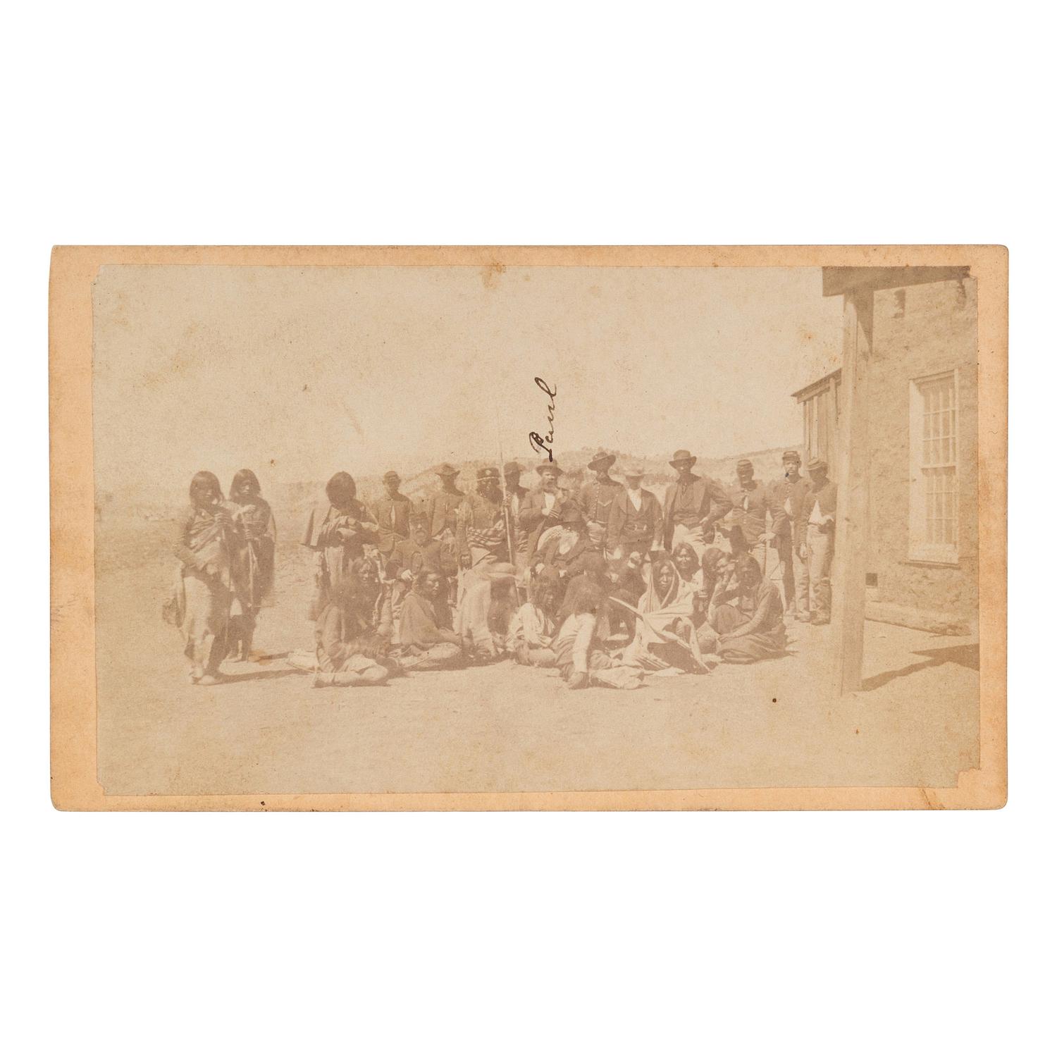 [NATIVE AMERICANS]. CDV of large group of Native Americans posed with soldiers and a civilian. N.p.: n.p., [ca 1860s].