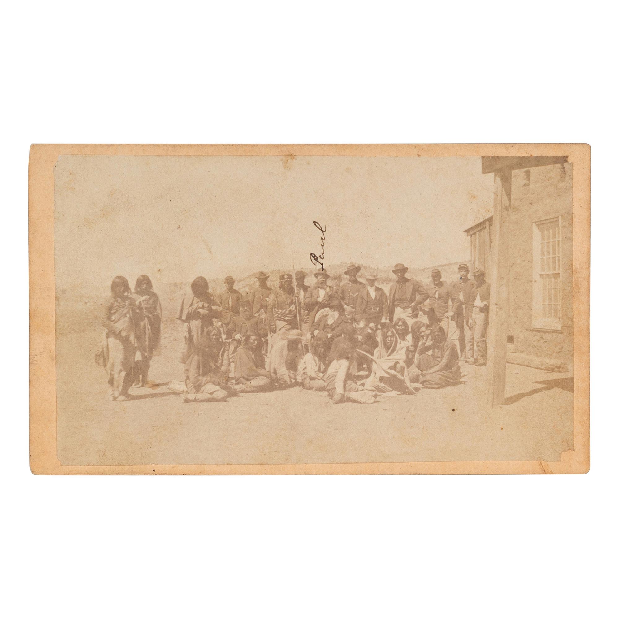 [NATIVE AMERICANS]. CDV of large group of Native Americans posed with soldiers and a civilian. N.p.: n.p., [ca 1860s].