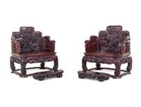 A Pair of Chinese Export Carved Hardwood Armchairs and Footrests