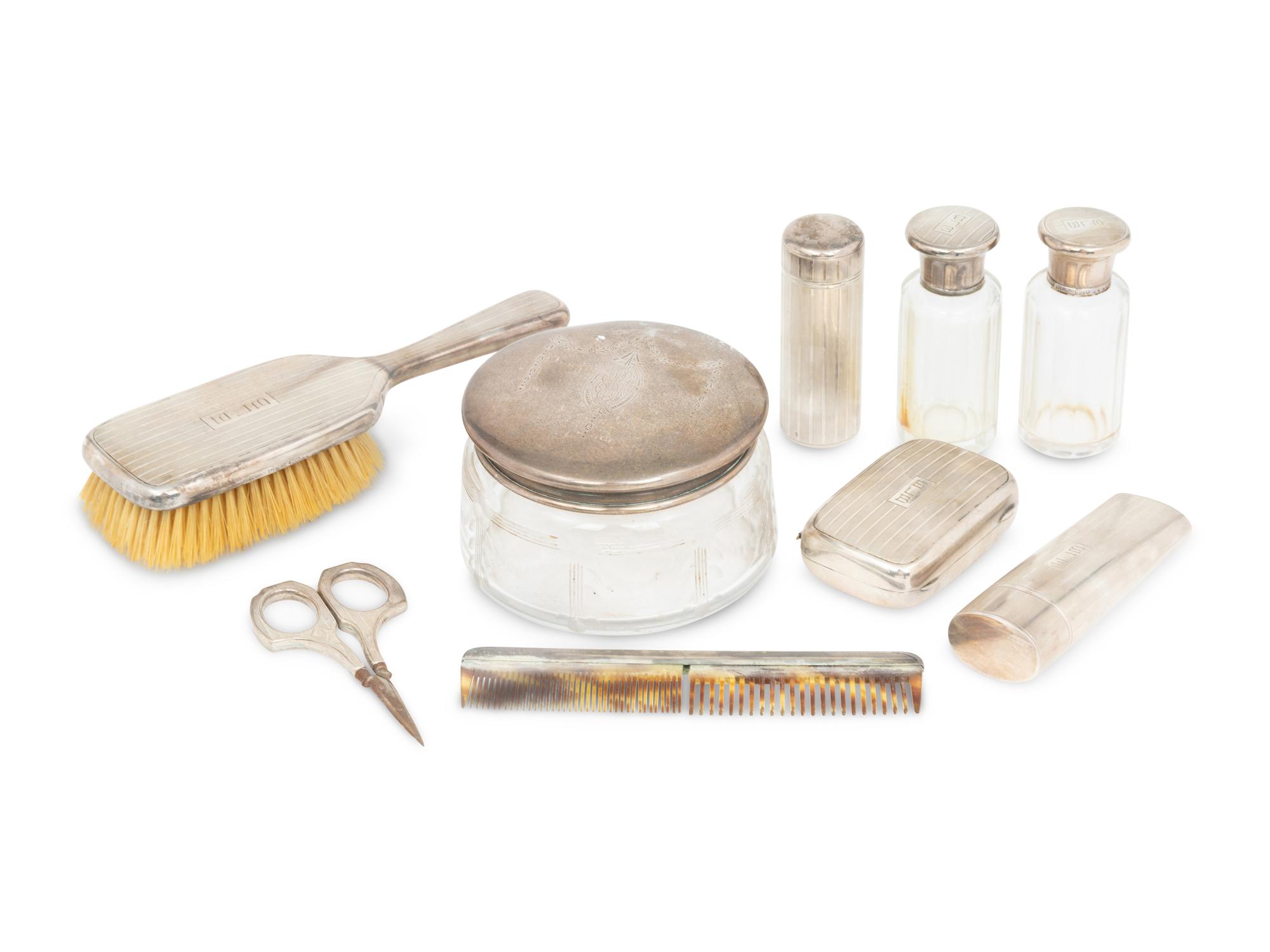 A Cased Gorham Silver Eighteen-Piece Travel Dresser Set Retailed by Cartier