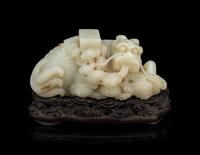 A Pale Celadon Jade 'Qilin and Book' Carving