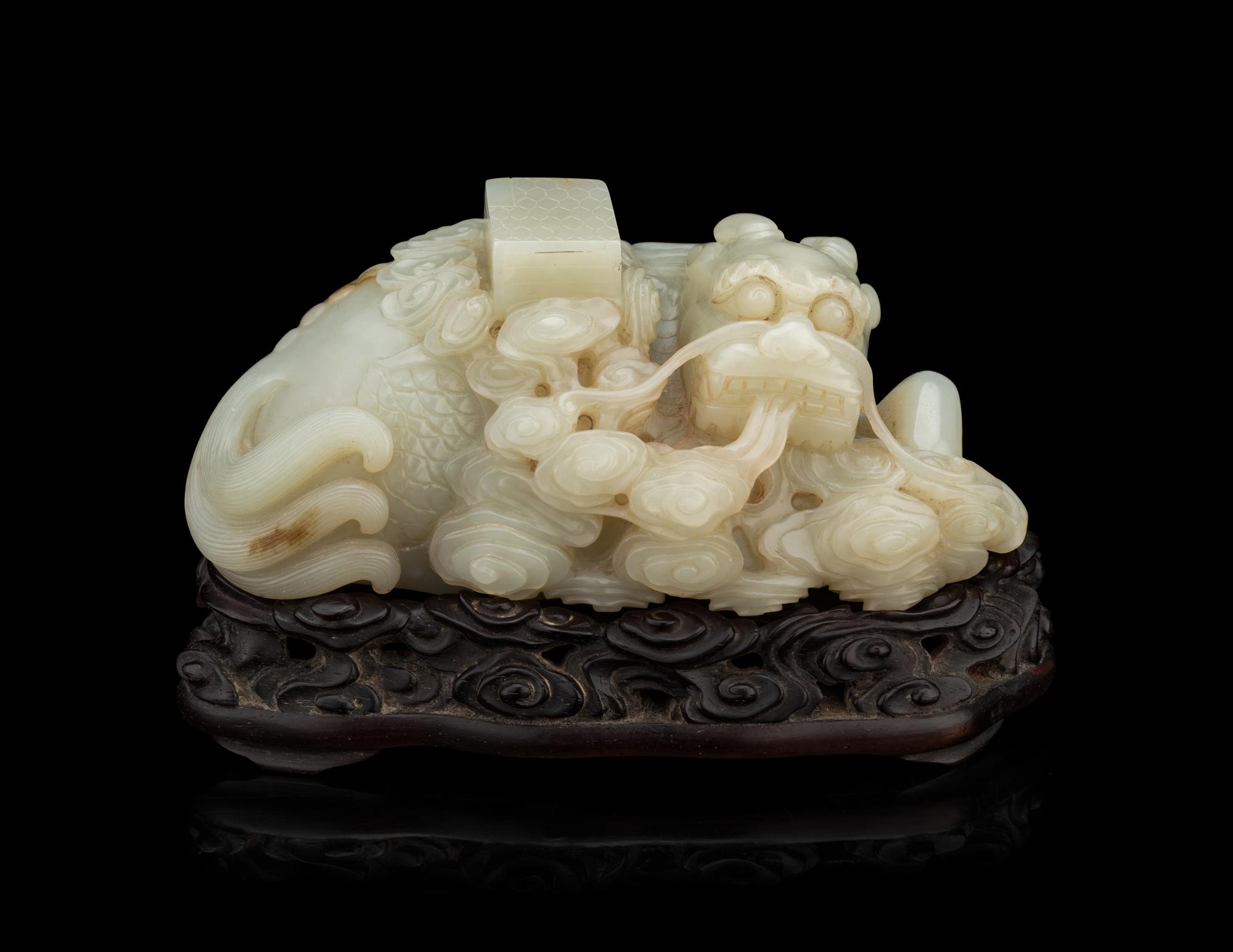 A Pale Celadon Jade 'Qilin and Book' Carving