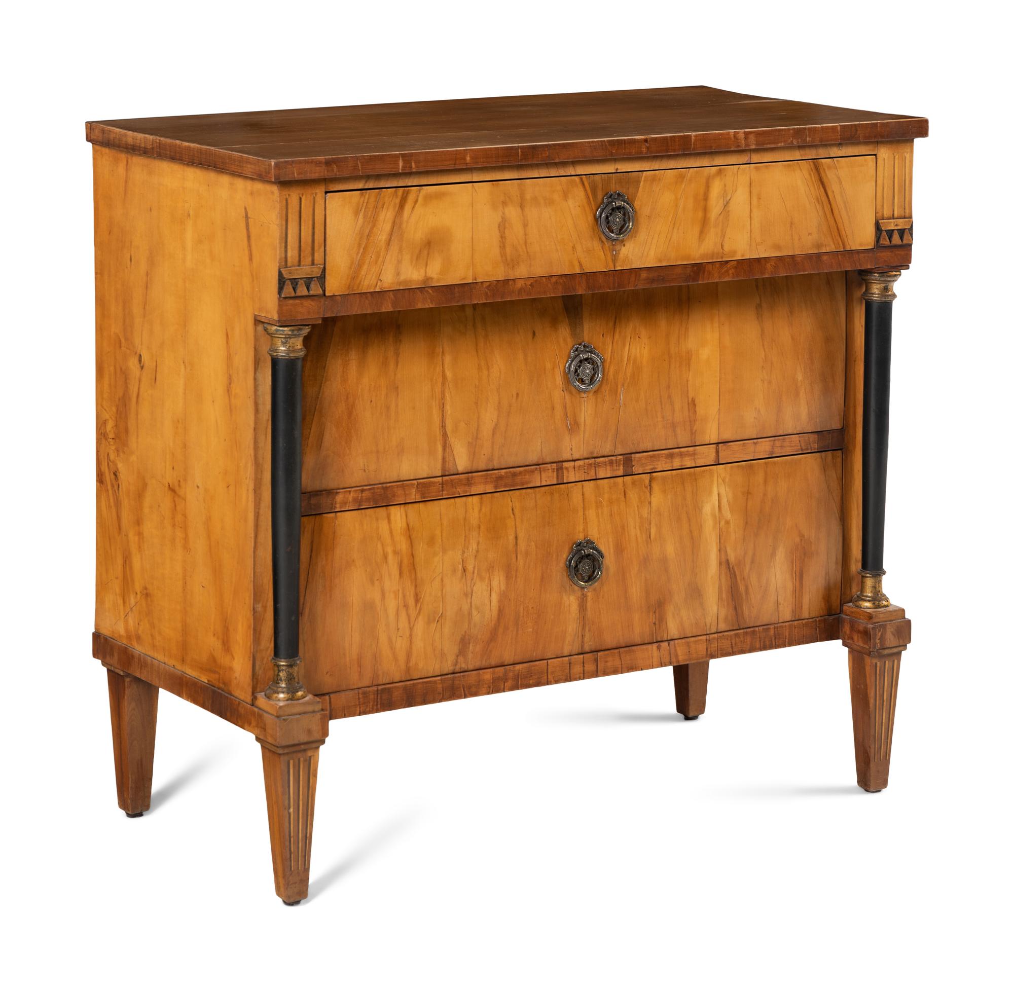 A Biedermeier Walnut and Parcel Ebonized Commode