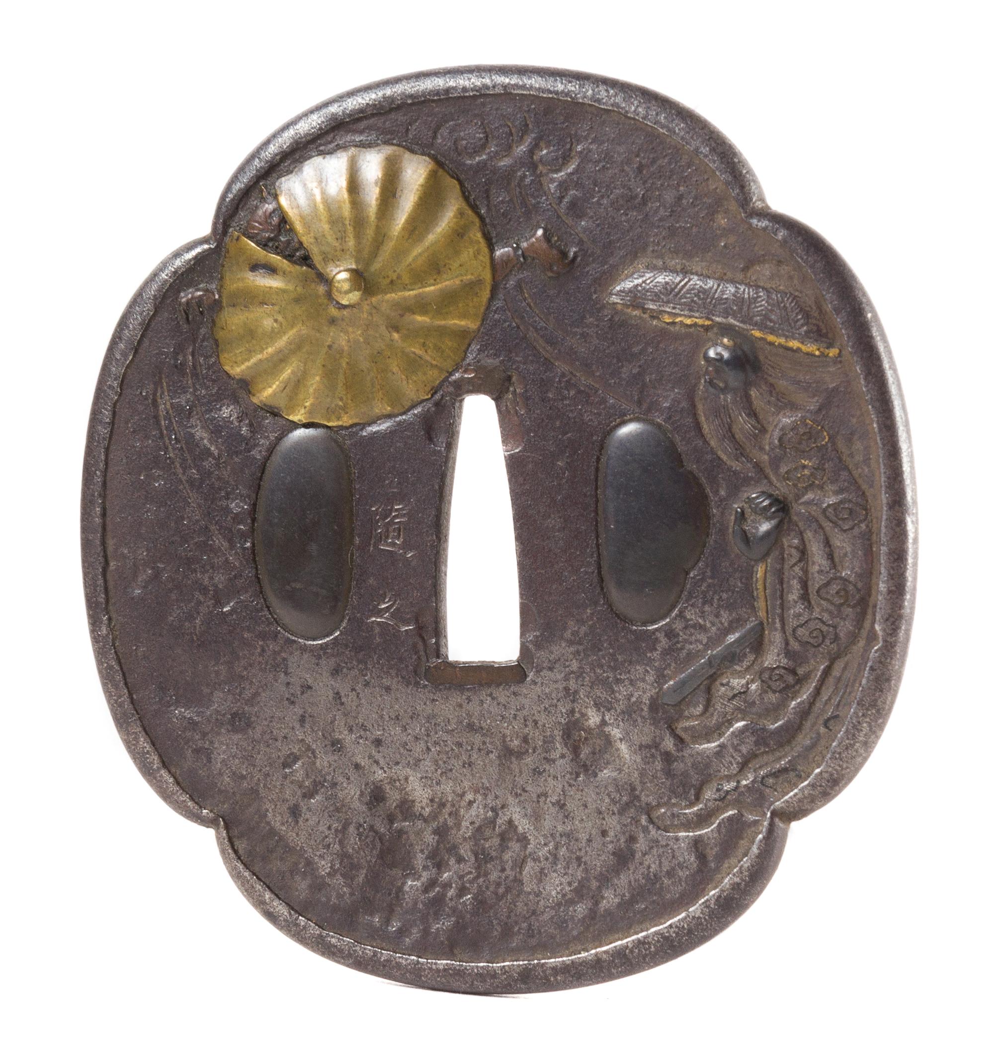 A Gilt Bronze Inlaid Iron Tsuba Height 3 1/4 inches.
