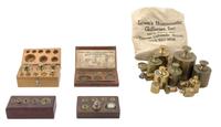 A Collection of Brass Weights Width of first case 5 inches.