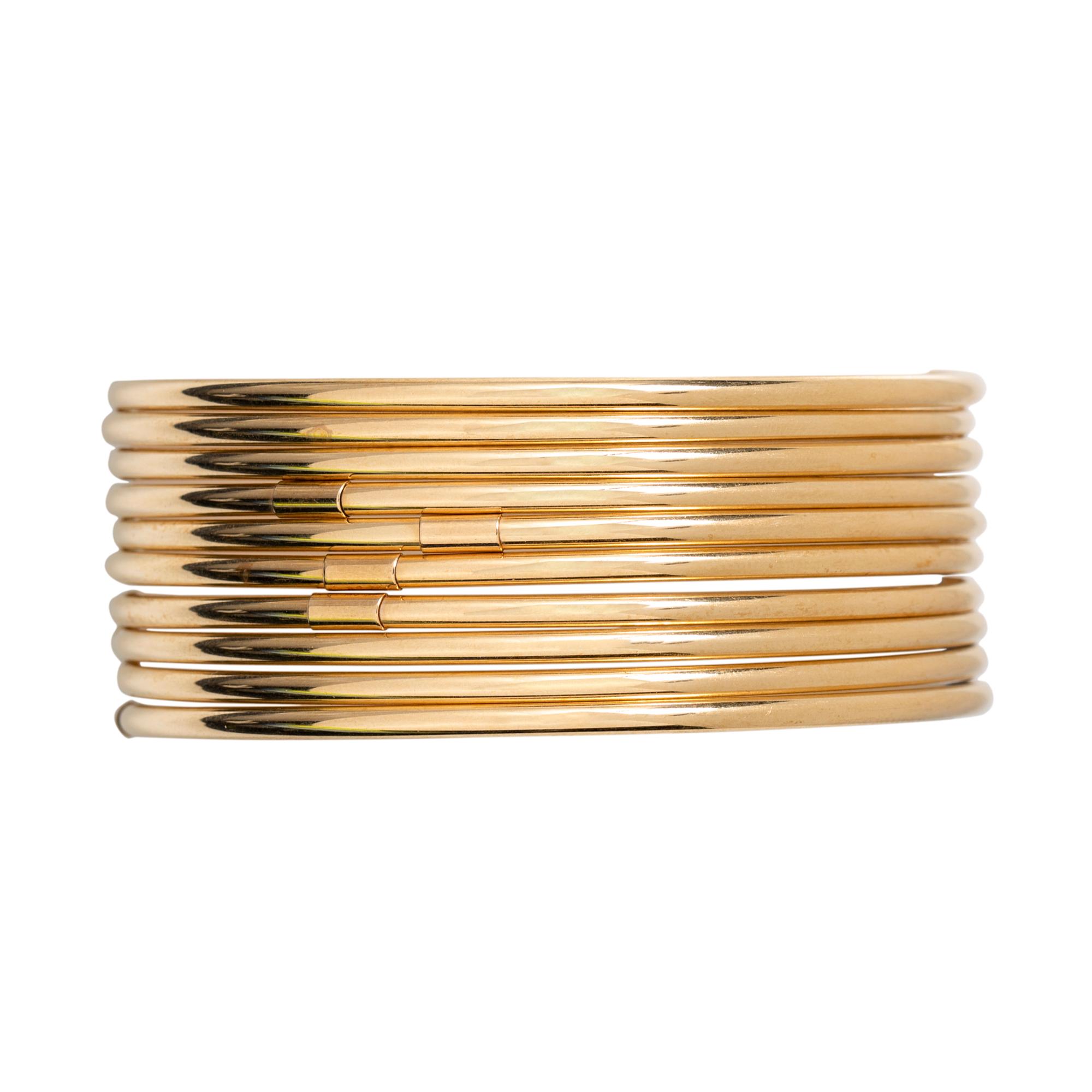 COLLECTION OF YELLOW GOLD BANGLE BRACELETS