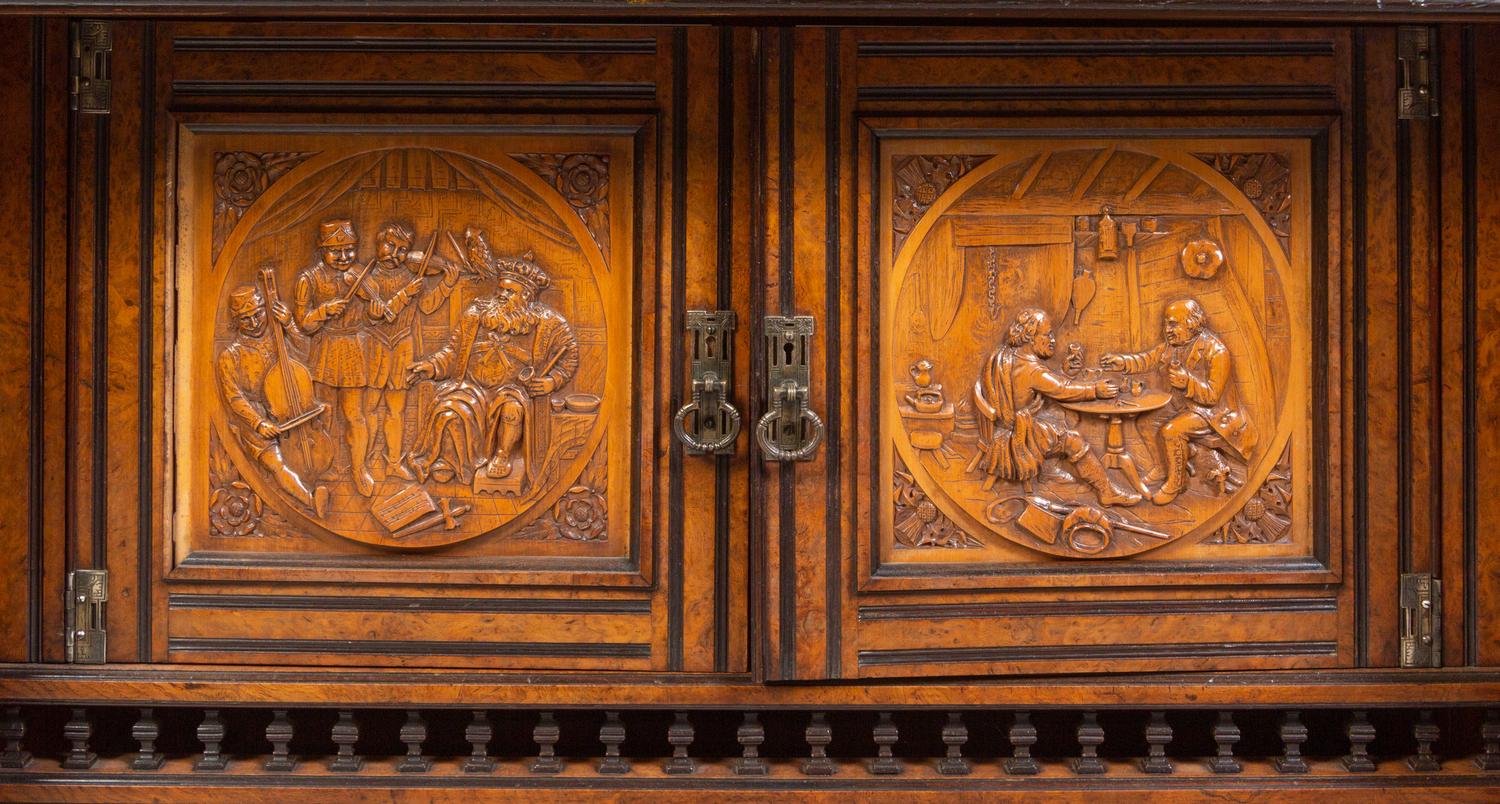 A Continental Carved Walnut and Burlwood Serving Cabinet