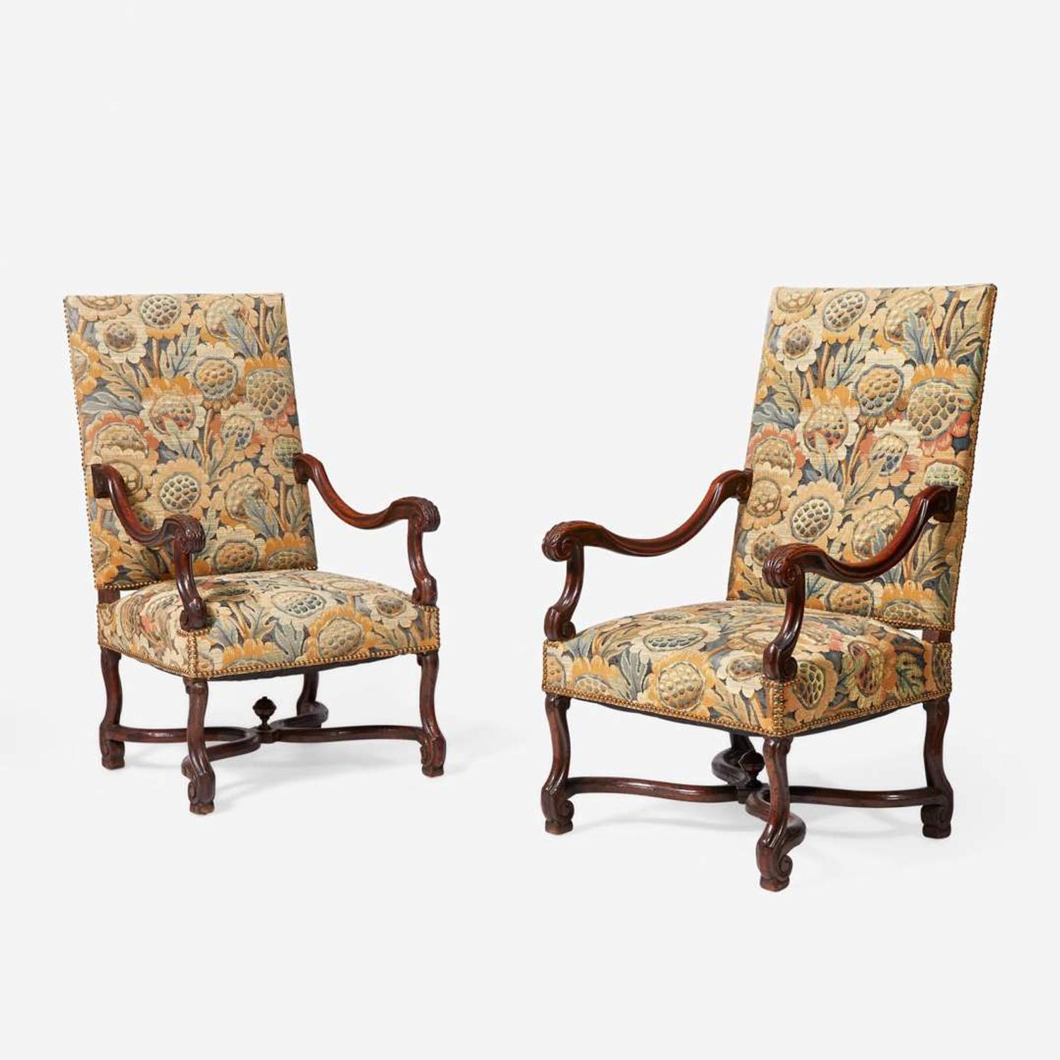 A pair of Baroque Revival carved walnut armchairs late 19th / early 20th century