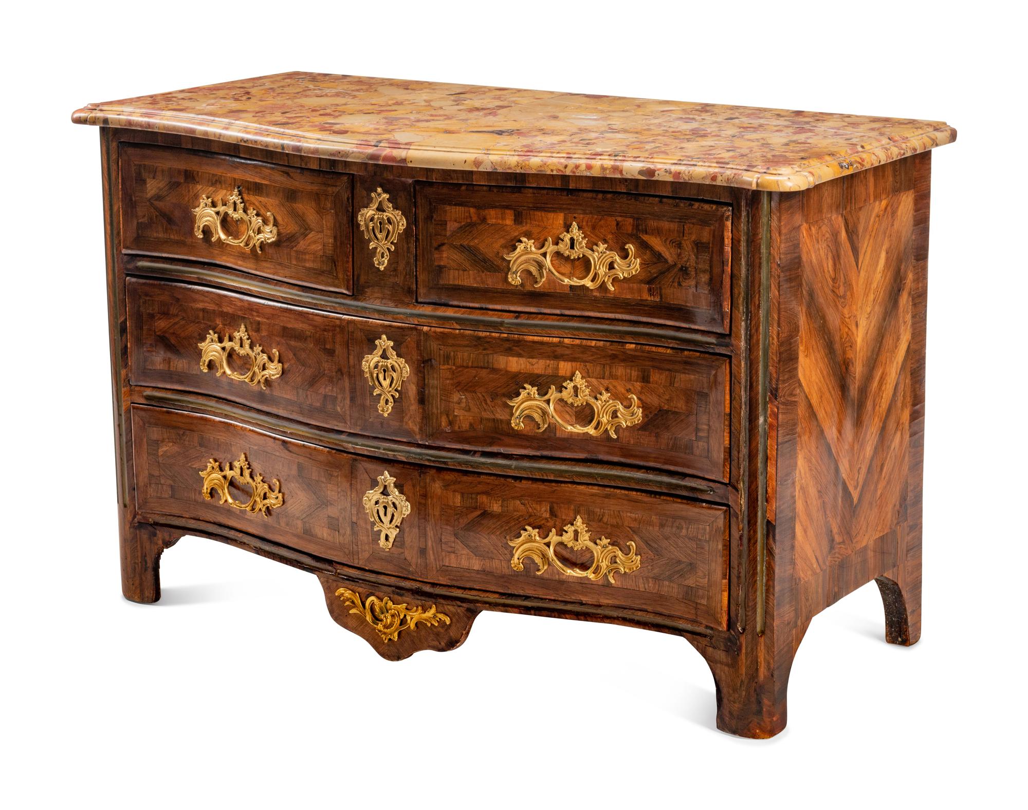 A Régence Gilt Bronze Mounted Tulipwood and Parquetry Marble-Top Commode