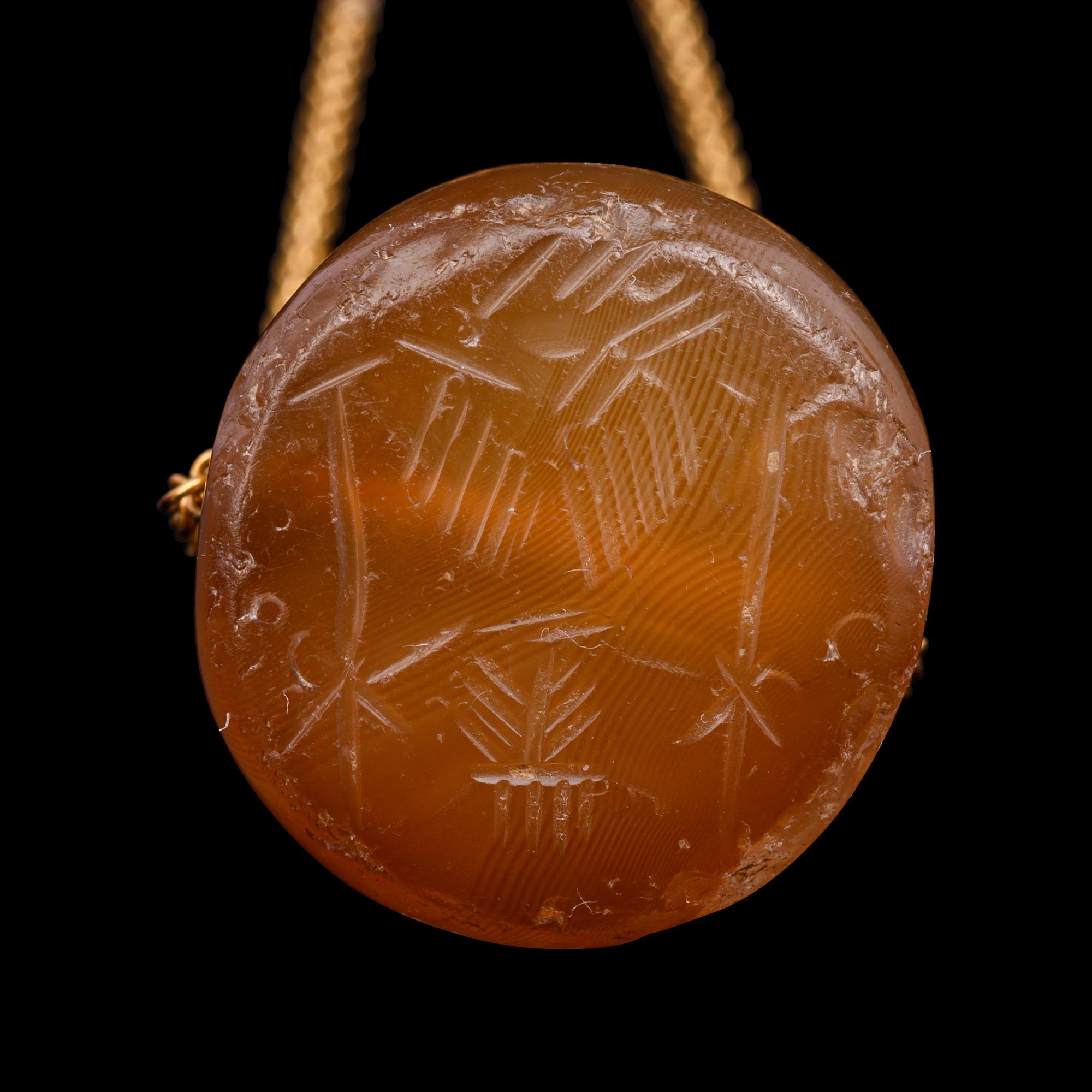 A Neo-Babylonian or Graeco-Persian Smokey Chalcedony Conoid Seal Necklace