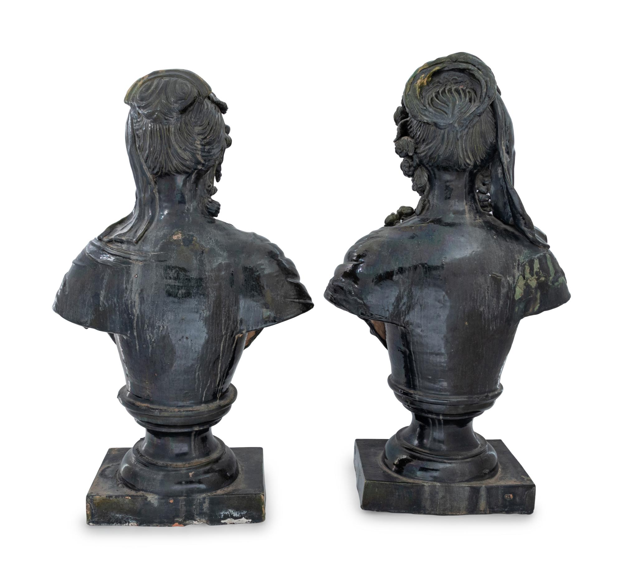 A Pair of French Green Glazed Terra Cotta Busts