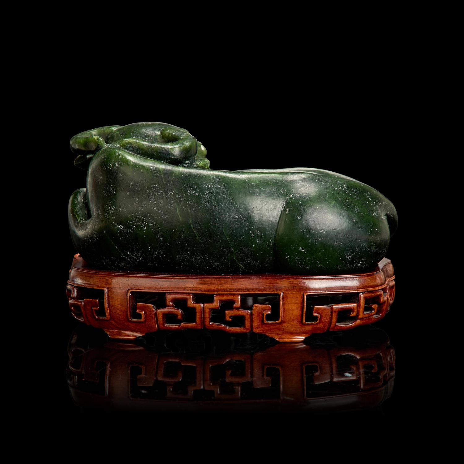 A Chinese Spinach Jade Buffalo, Qing Dynasty 清 青玉臥牛