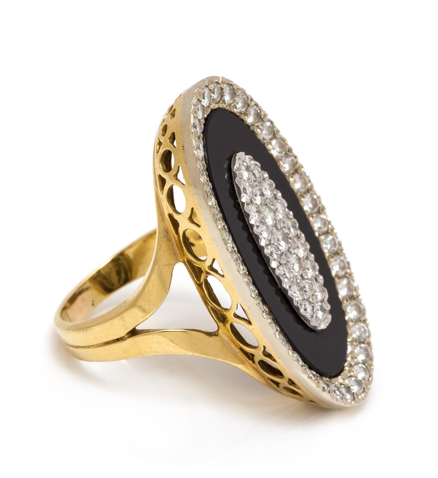An 18 Karat Bicolor Gold, Diamond and Onyx Ring, 8.75 dwts.