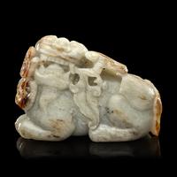 A Chinese Russet and Greyish Celadon Jade Figure of a Recumbent Qilin 青玉麒麟