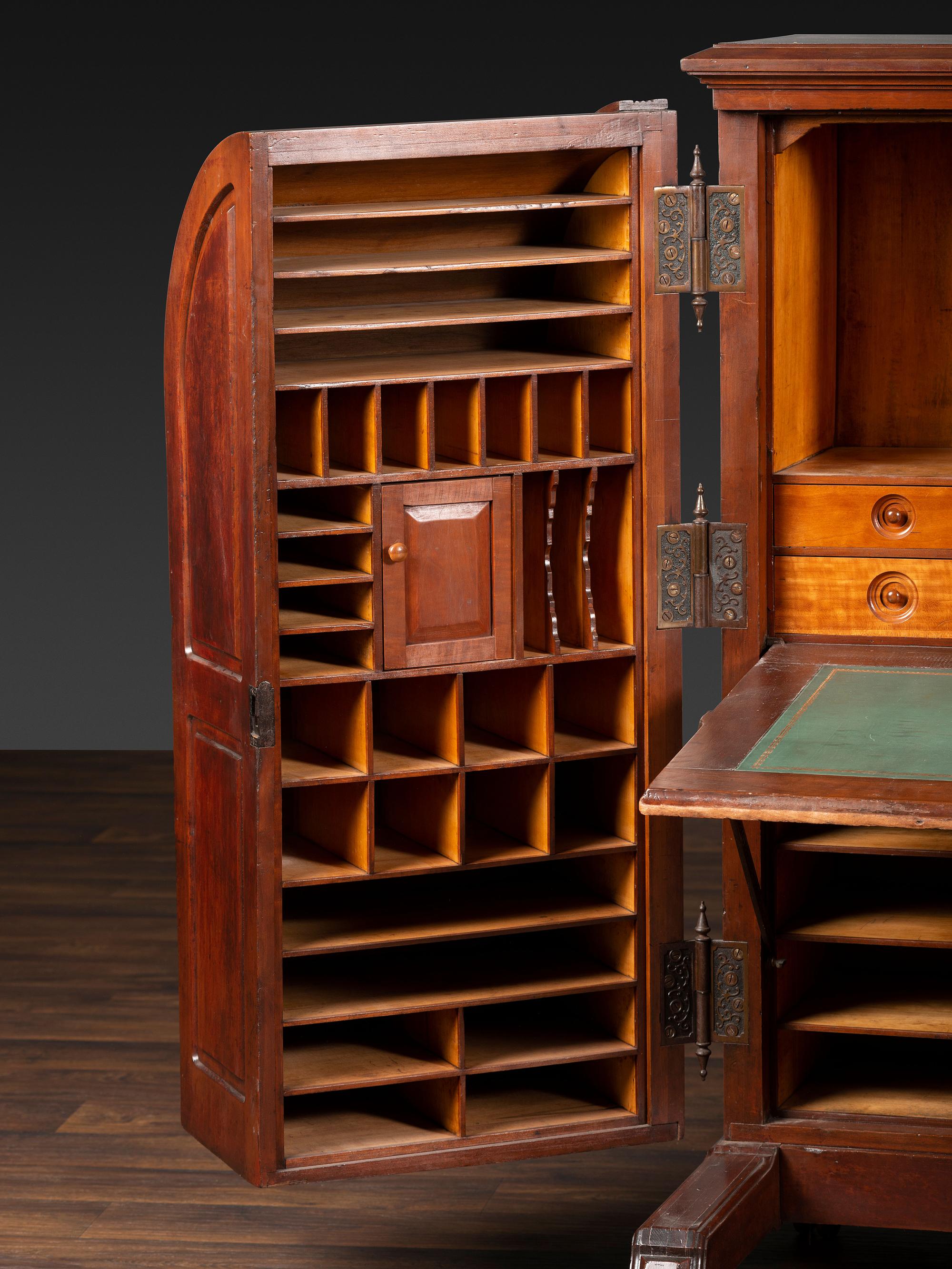 A Carved Walnut Wooton Secretary Desk