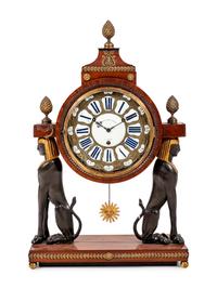 A French Egyptian Revival Gilt Bronze Mounted Mahogany Clock