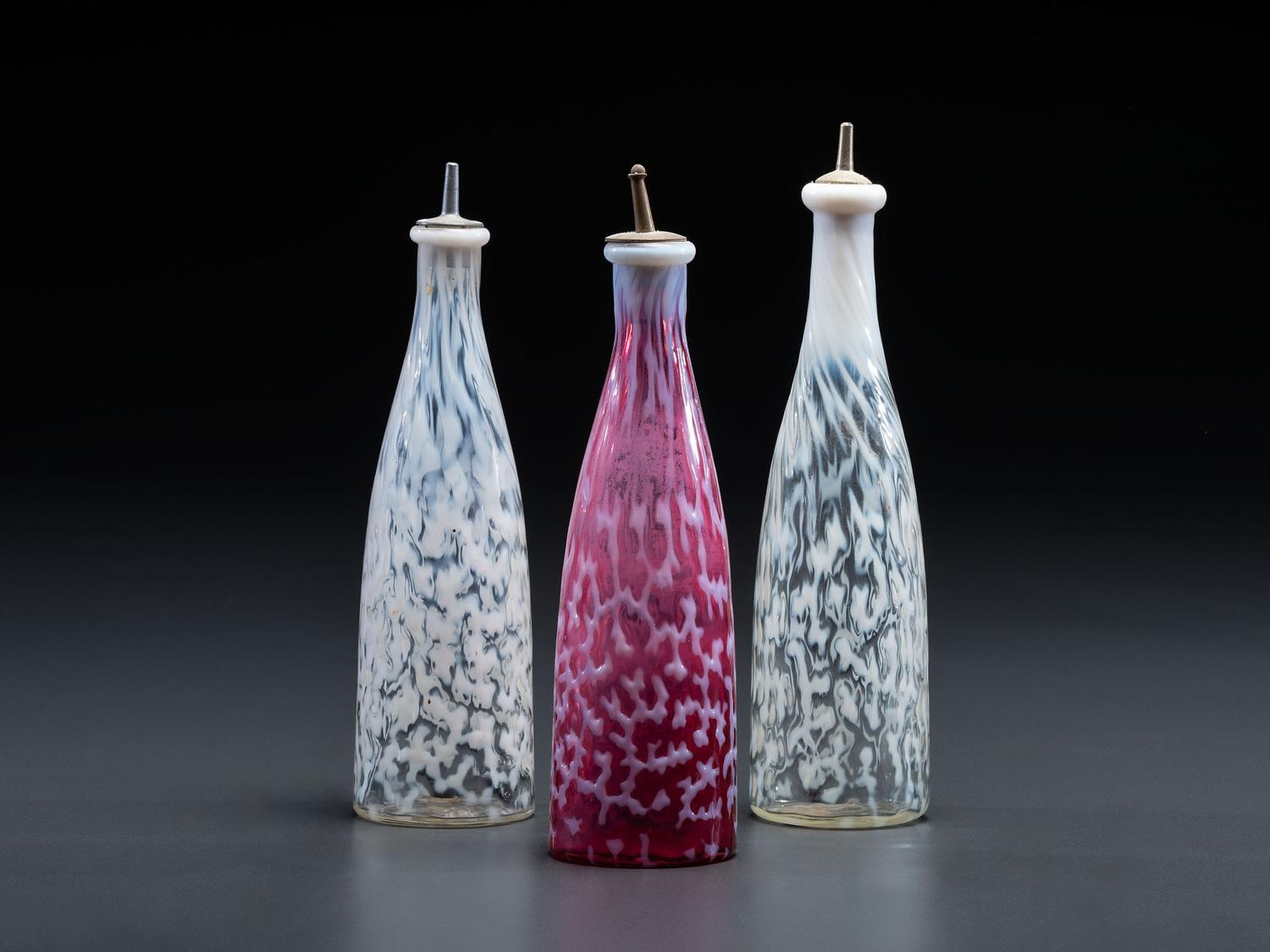 Three Coral Opalescent Glass Barber Bottles