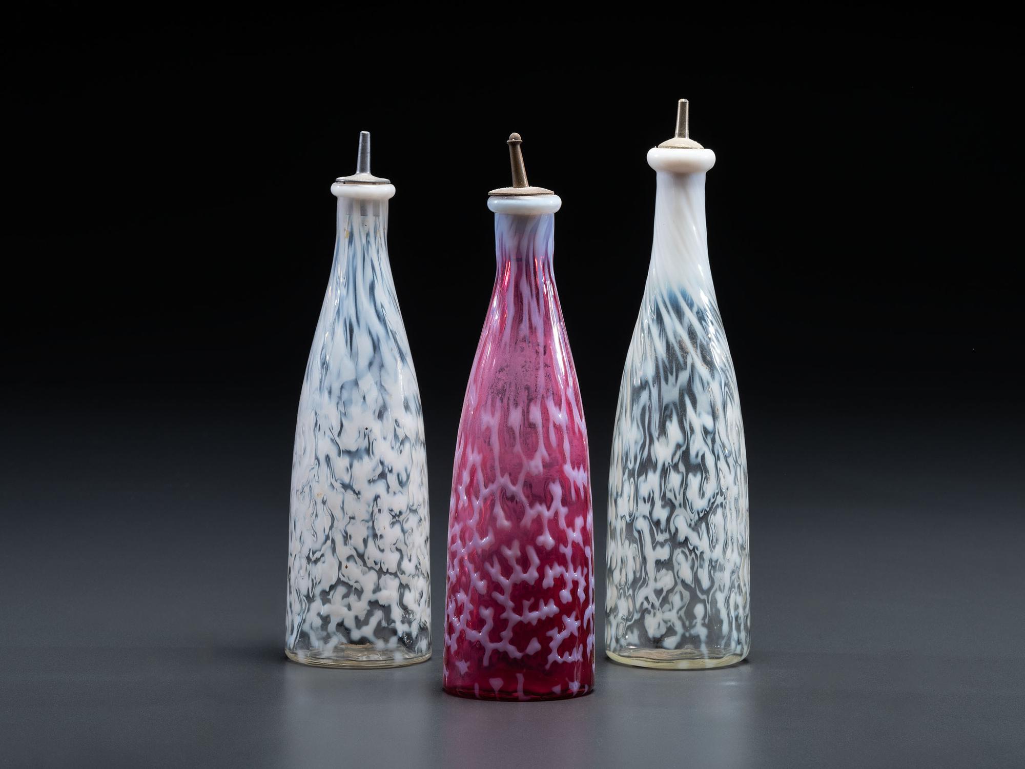 Three Coral Opalescent Glass Barber Bottles