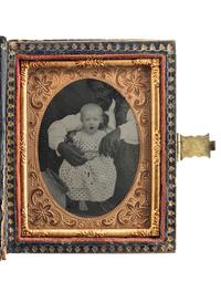 [EARLY PHOTOGRAPHY]. Ninth plate ambrotype of an African American man with white child, with rare Colonoware jar.