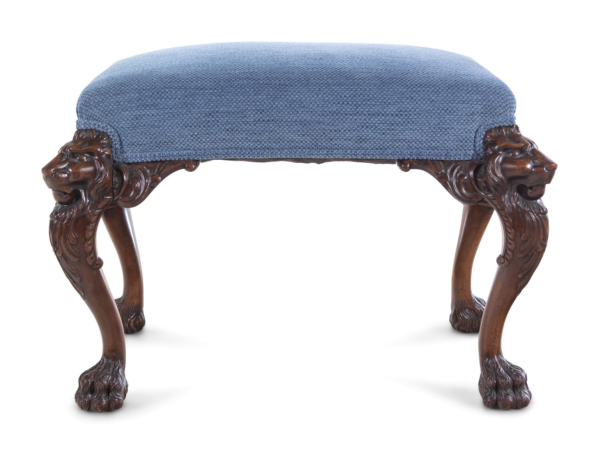 An Edwardian Carved Mahogany Foot Stool
