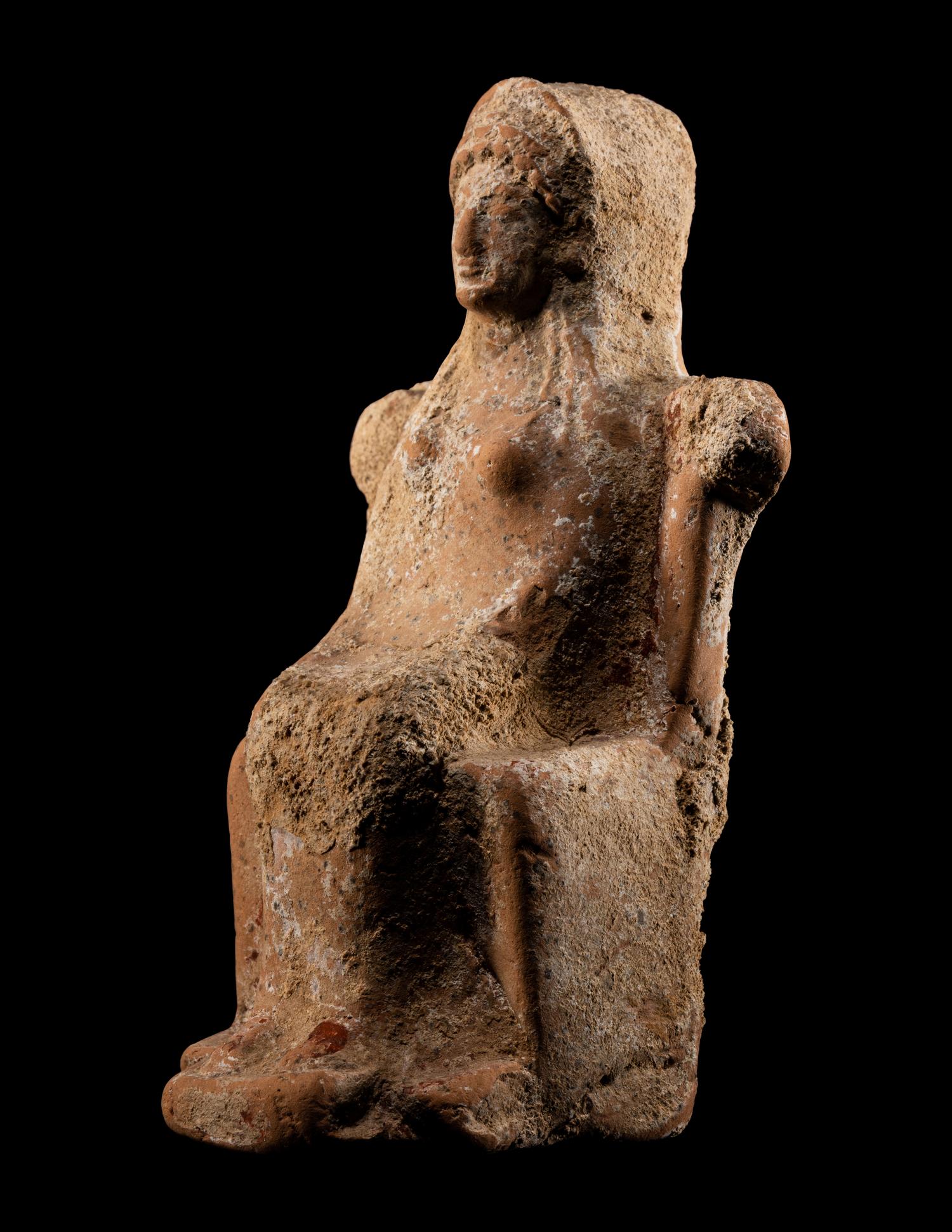 A Greek Terracotta of a Seated Female Deity