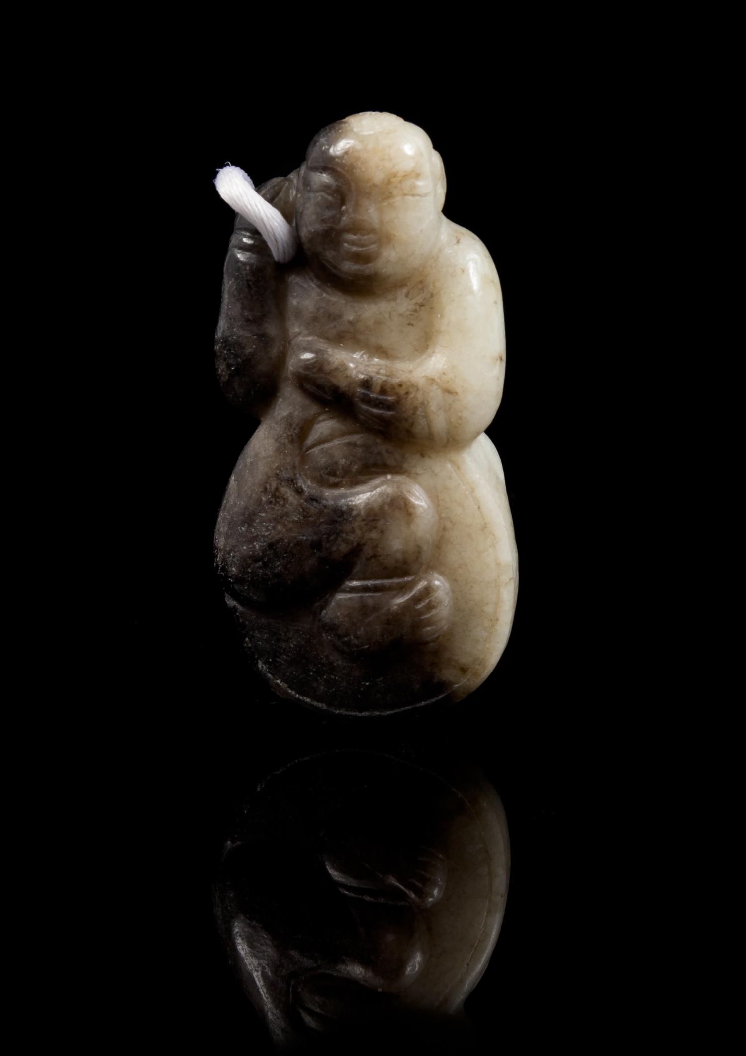 A Carved Jade Toggle Length 2 1/2 inches.