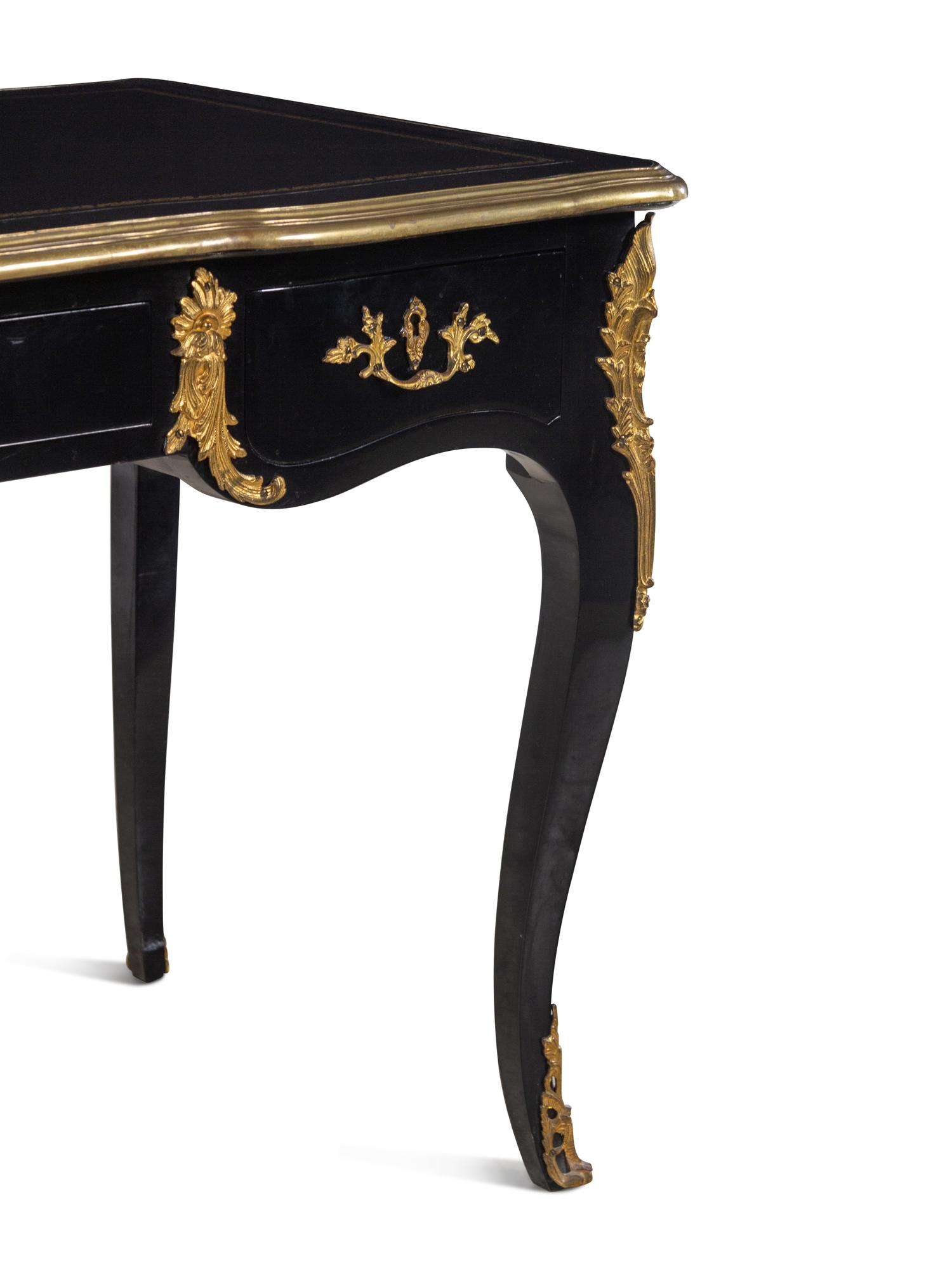 A Louis XV Style Gilt Metal Mounted Ebonized Bureau Plat
