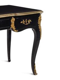 A Louis XV Style Gilt Metal Mounted Ebonized Bureau Plat