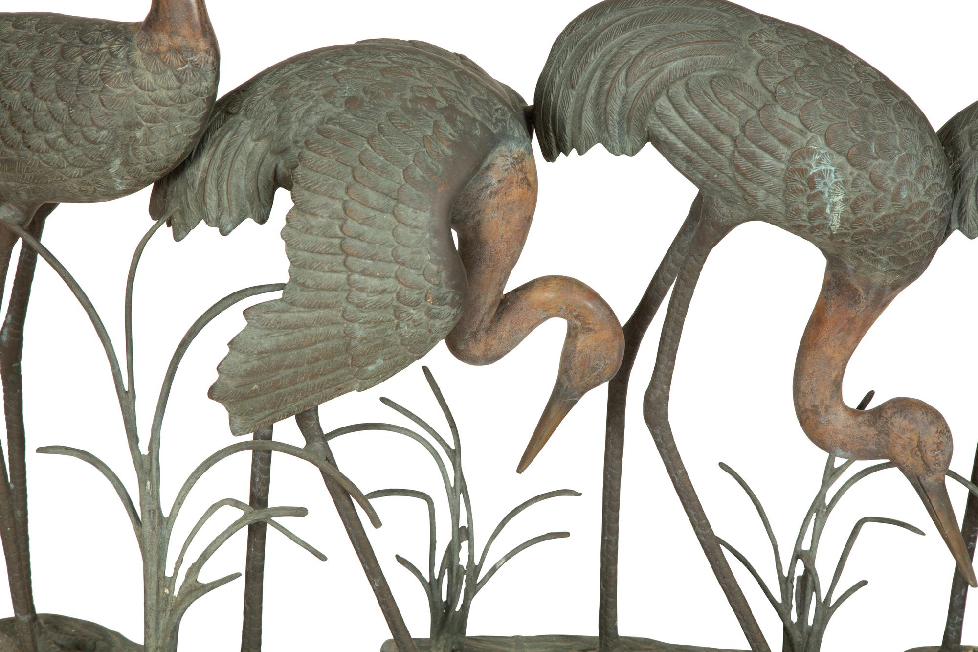 A Bronze Sculpture of Four Standing Cranes