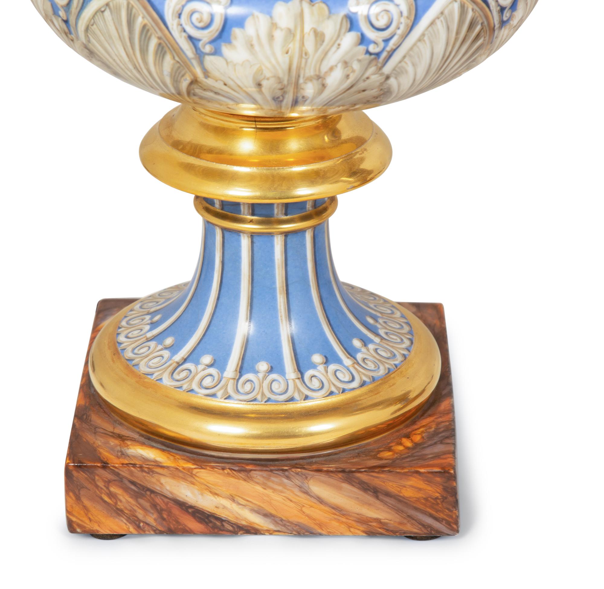 A Pair of Continental Parcel-Gilt and Polychrome Painted Porcelain Urns
