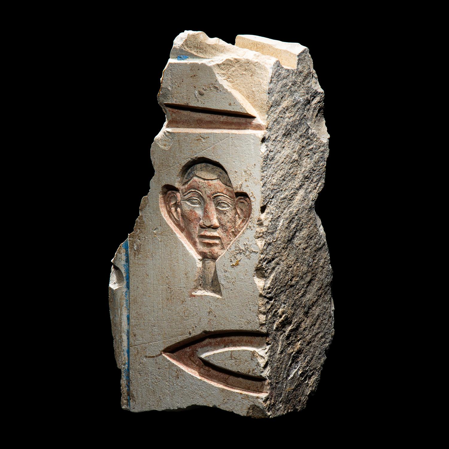 An Egyptian Painted Limestone Relief Fragment
