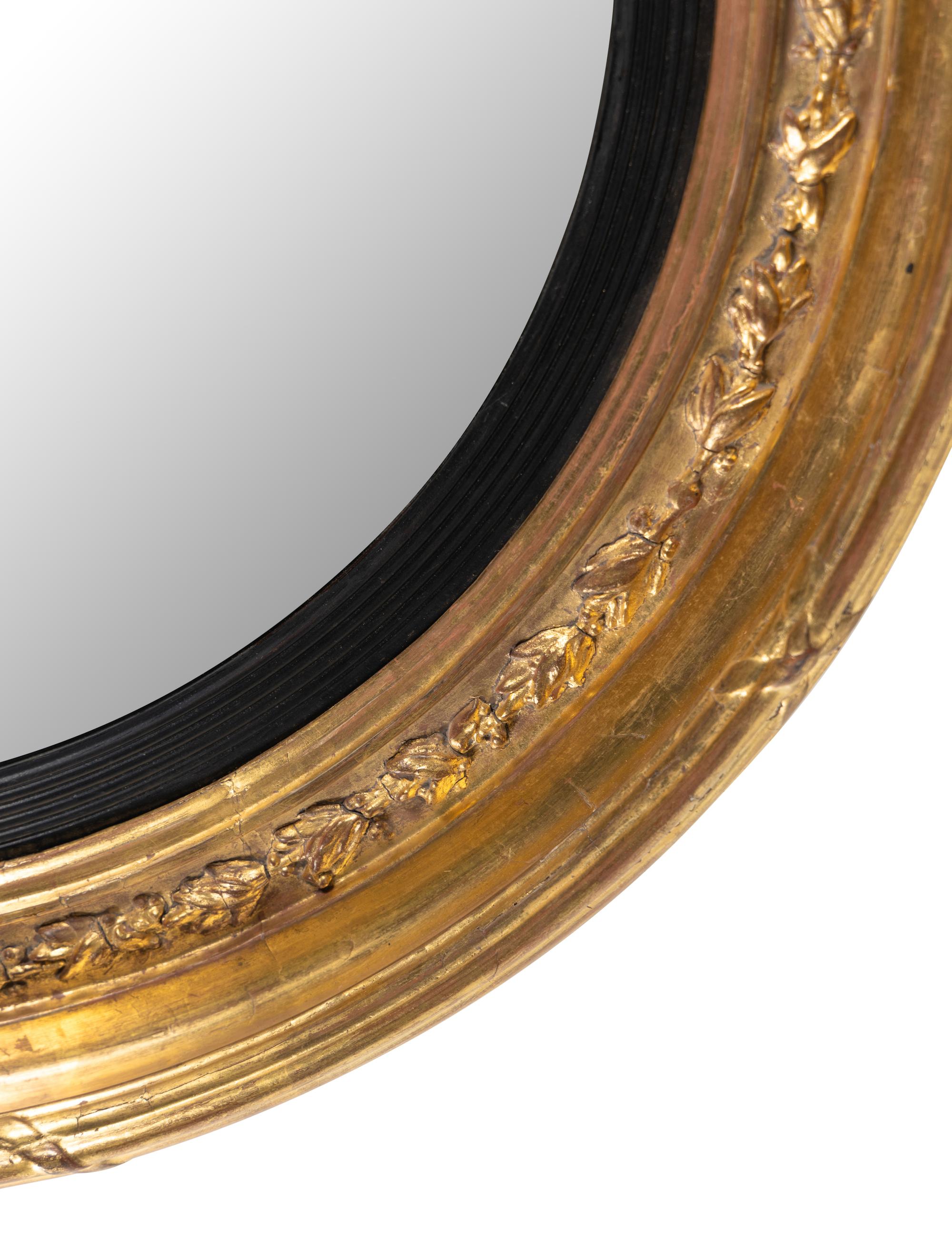 A Regency Giltwood and Parcel Ebonized Mirror