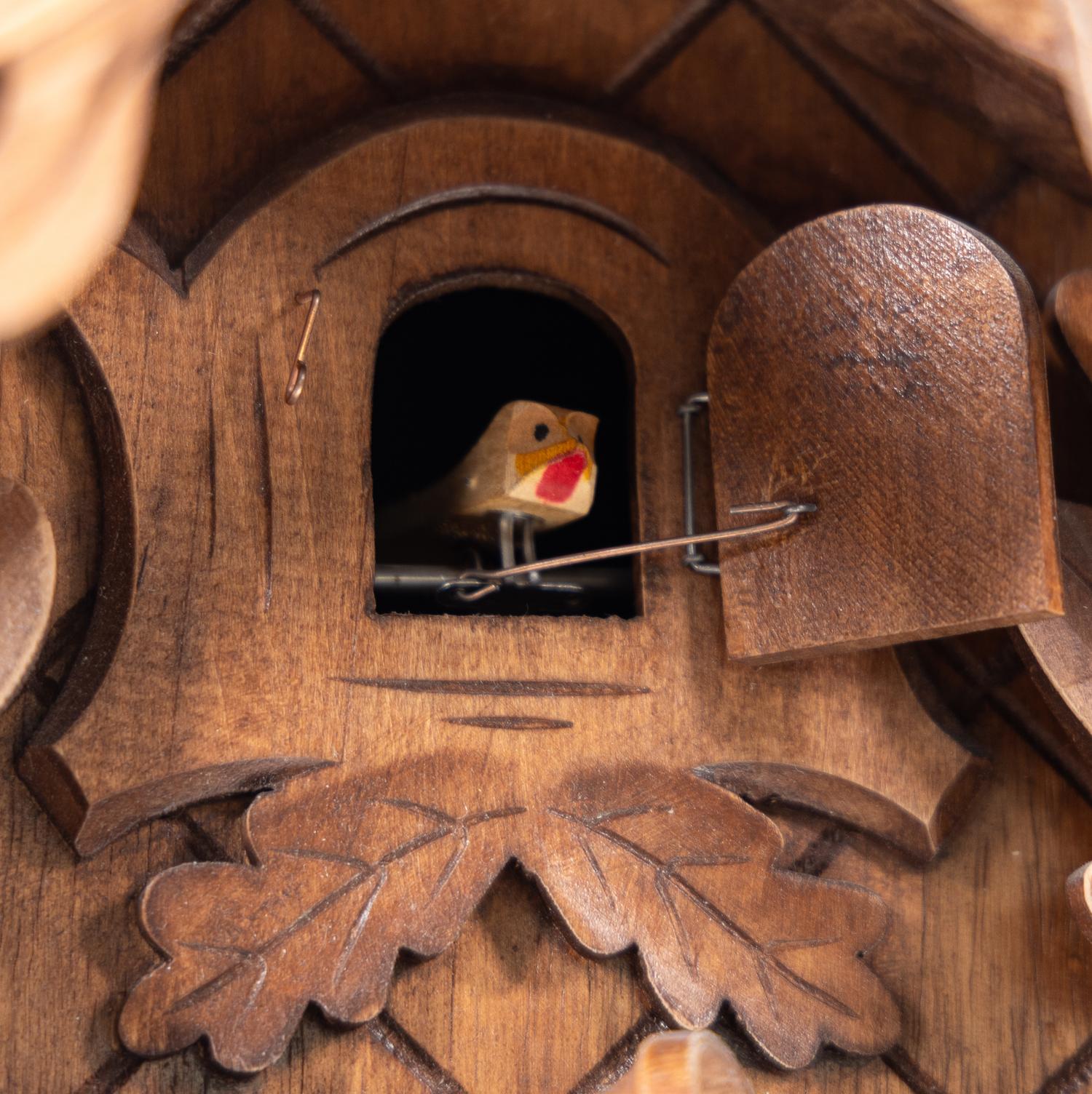 A Black Forest Style Carved Walnut Cuckoo Clock