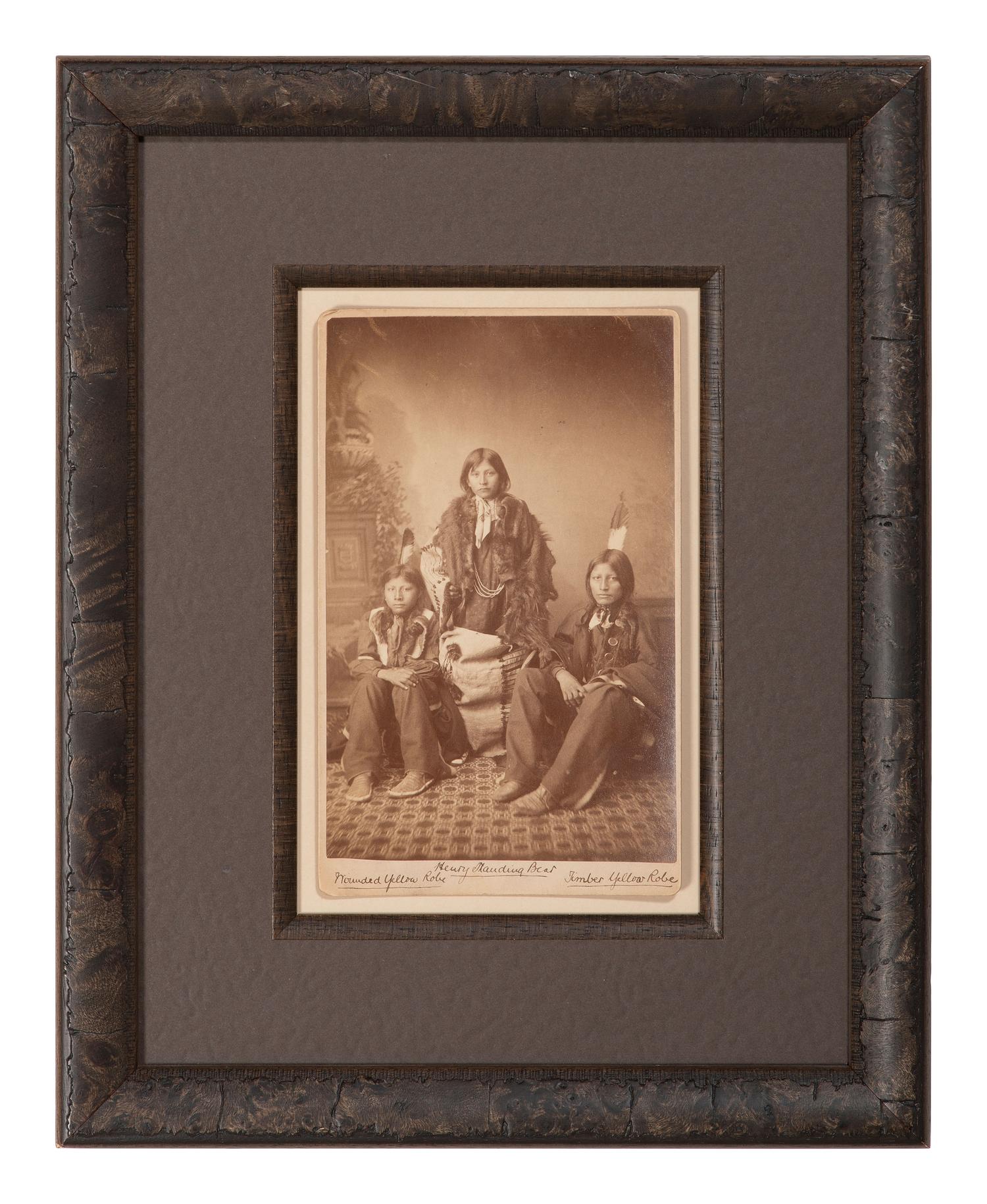 CHOATE, John N. (1848-1902), photographer. Boudoir card featuring a trio of Santee Sioux students of Carlisle Indian School, identified on mount as Henry Standing Bear, Wounded Yellow Robe, and Timber Yellow Robe. Carlisle, PA, ca 1883.