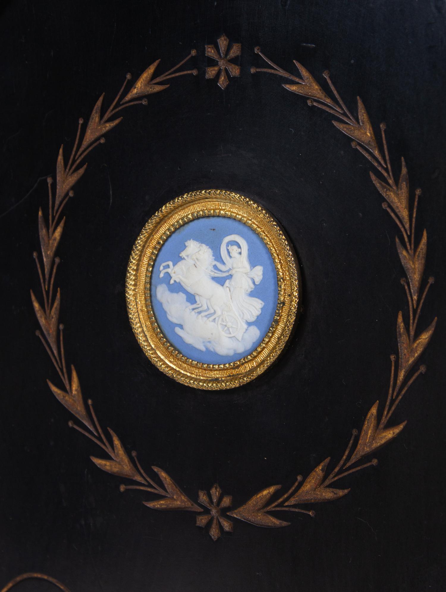 A Pair of English Aesthetic Jasperware Medallion-Mounted Ebonized and Parcel-Gilt Pedestal Cabinets