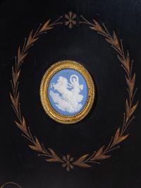 A Pair of English Aesthetic Jasperware Medallion-Mounted Ebonized and Parcel-Gilt Pedestal Cabinets